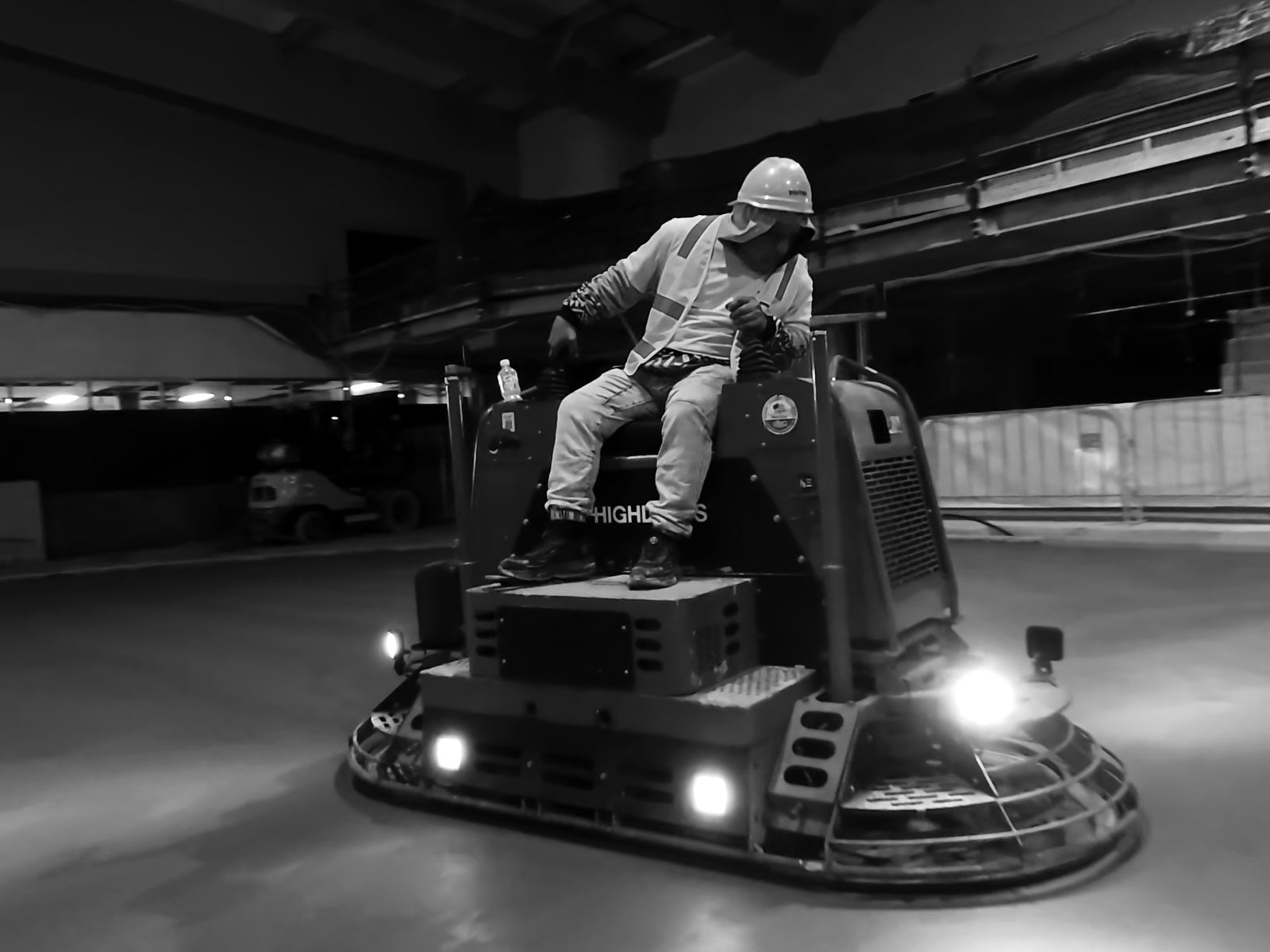 Allen ride-on trowel working the competition ice slab under lights