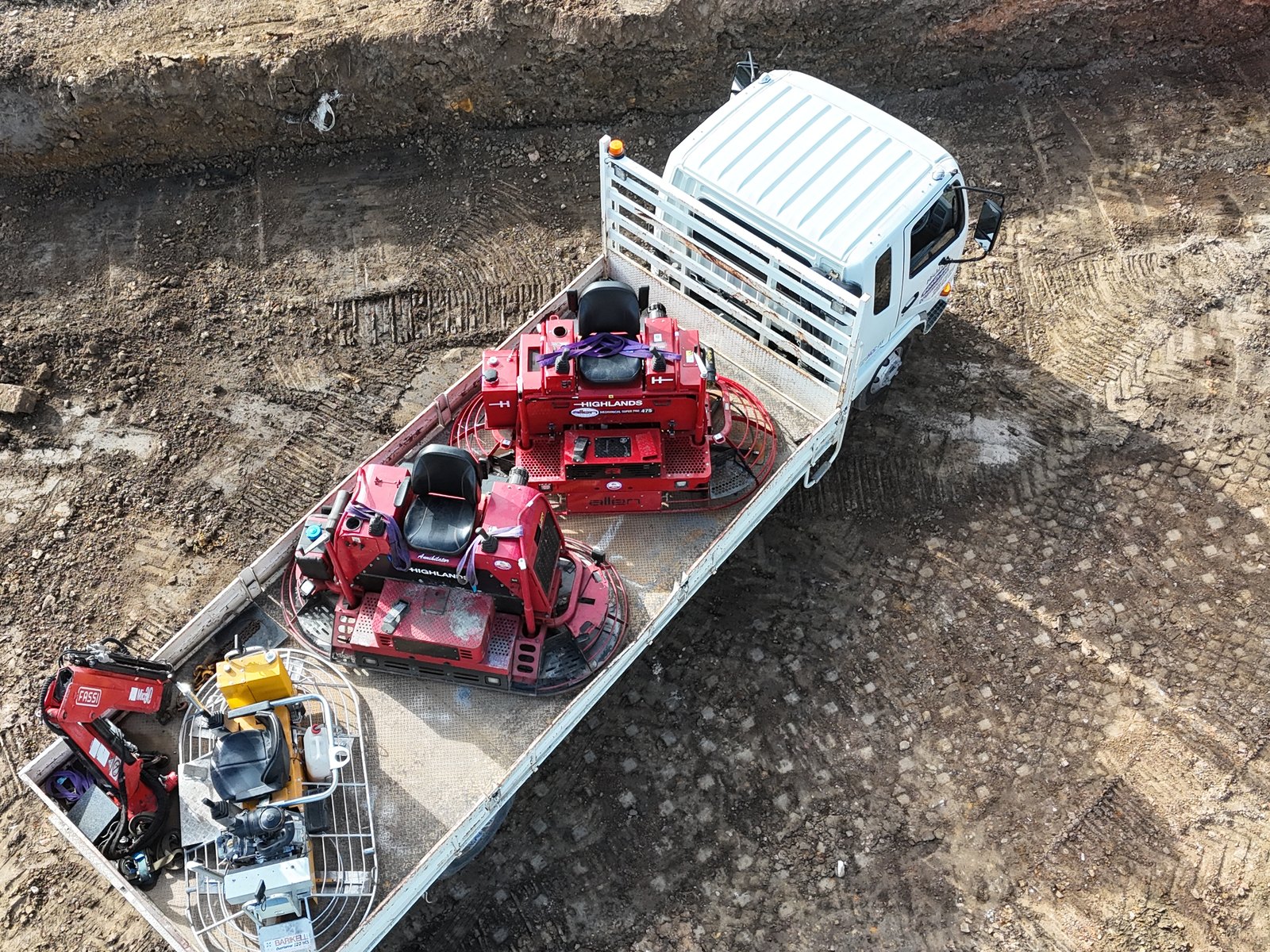 Aerial view of the Highlands crane truck carrying ride-on power trowels and finishing equipment