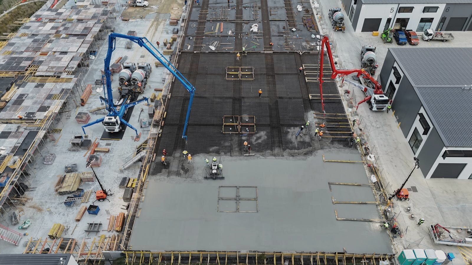Industrial estate warehouse floor pour, aerial drone view