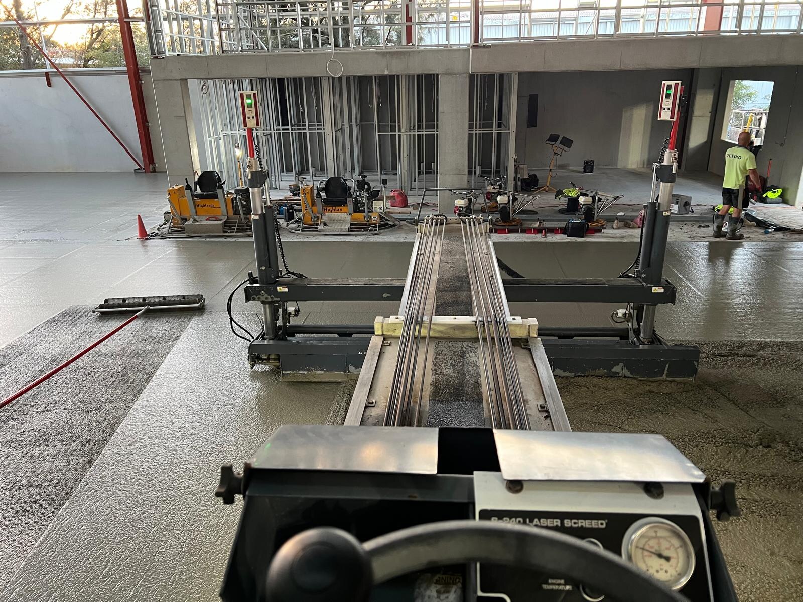 View from the laser screed seat with trowel machines beyond