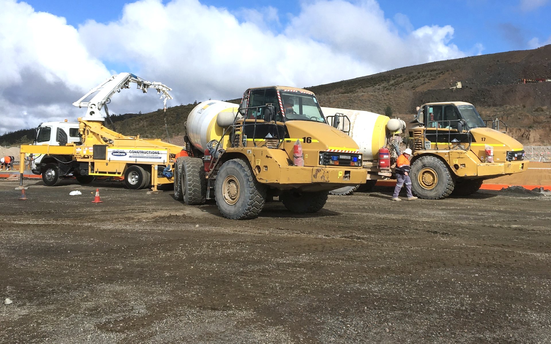 Highlands boom pump and two off-road agitator trucks on a remote mine site pour