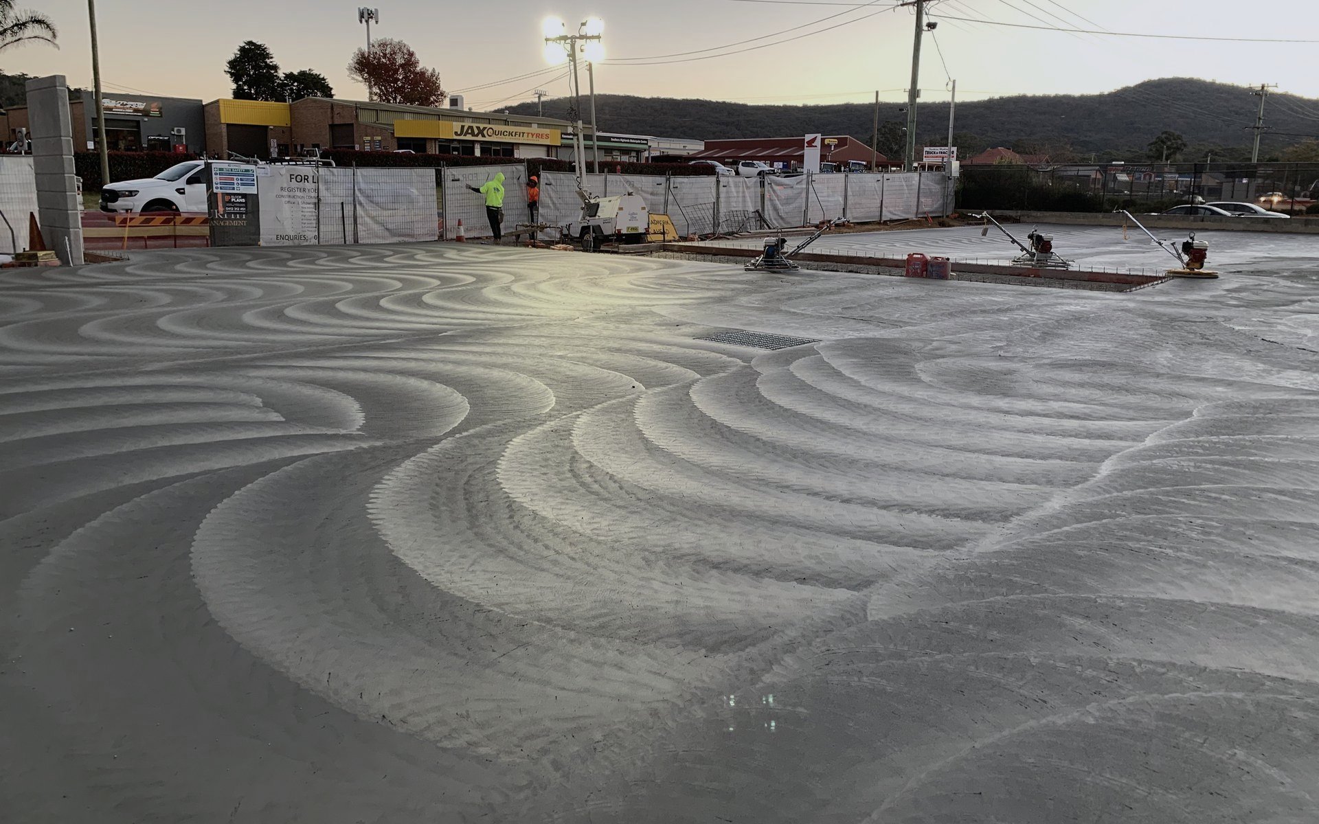 Sweeping snake pattern texture worked across a large external slab at dusk